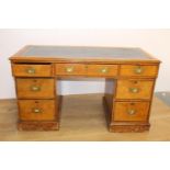 19th. C. oak knee hole writing desk the tooled leather top above a long drawer flanked by six