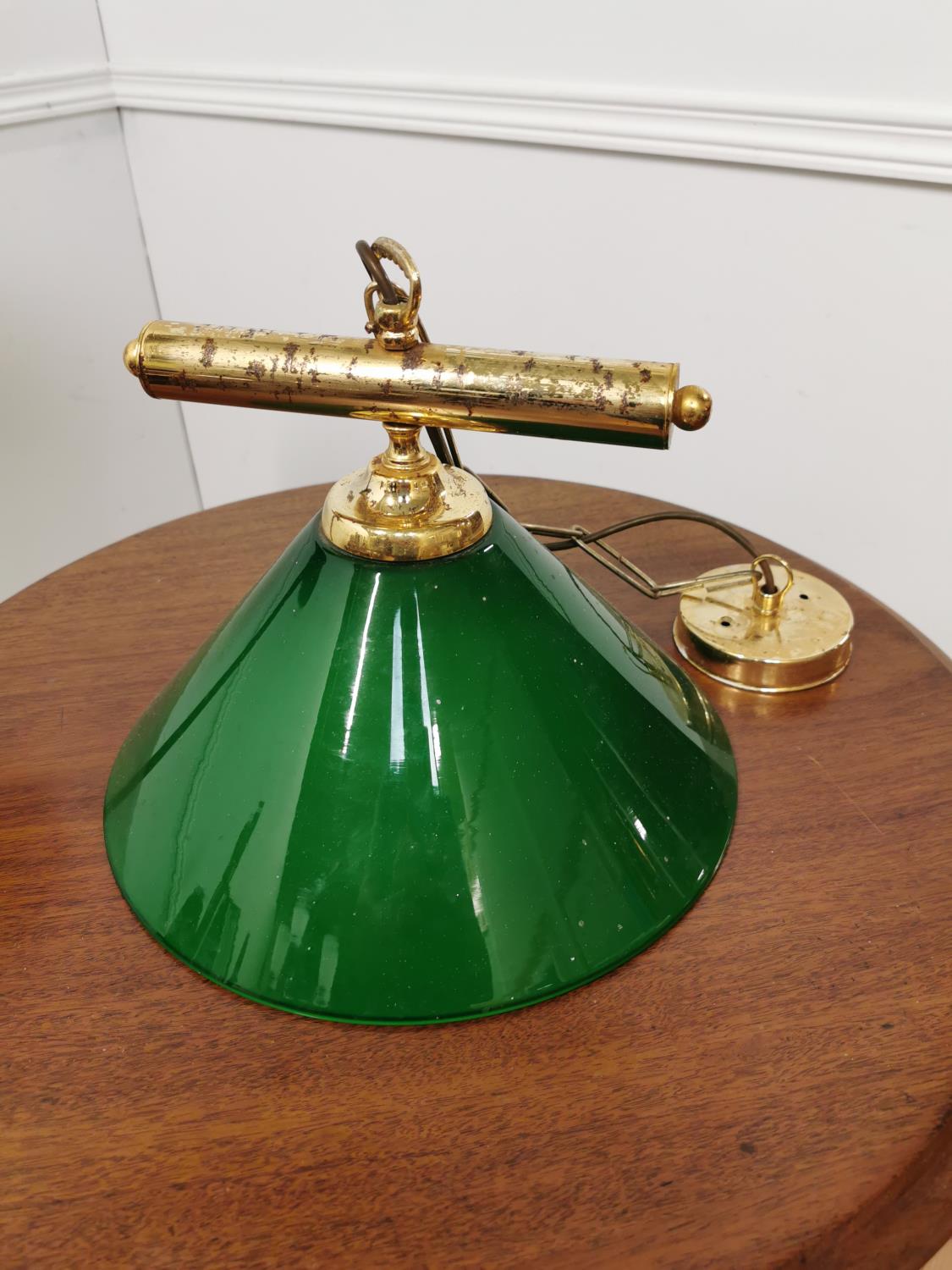 Brass hanging light with green glass shade { 60cm H X30cm W }.