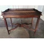 Georgian mahogany tea table in the Chippendale style with pierced gallery raised on four tapered