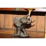 Bronze model of an elephant holding a lotus flower { 23cm H X 32cm W X 12cm D }.