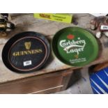 Guinness tin plate advertising drink’s tray and Carlsberg tin plate drink’s tray . {30 cm Dia}.