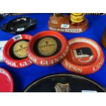 Three Guinness tin plate advertising ashtrays. {20 cm Dia}.