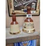 Two Bell’s Old Scotch Whiskey advertising figures. {21 cm H x 12 cm Dia} and {16 cm H x 9 cm Dia}.