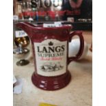 Lang’s Supreme Scotch Whiskey ceramic advertising water jug. {15 cm H x 17 cm W x 11 cm D}.