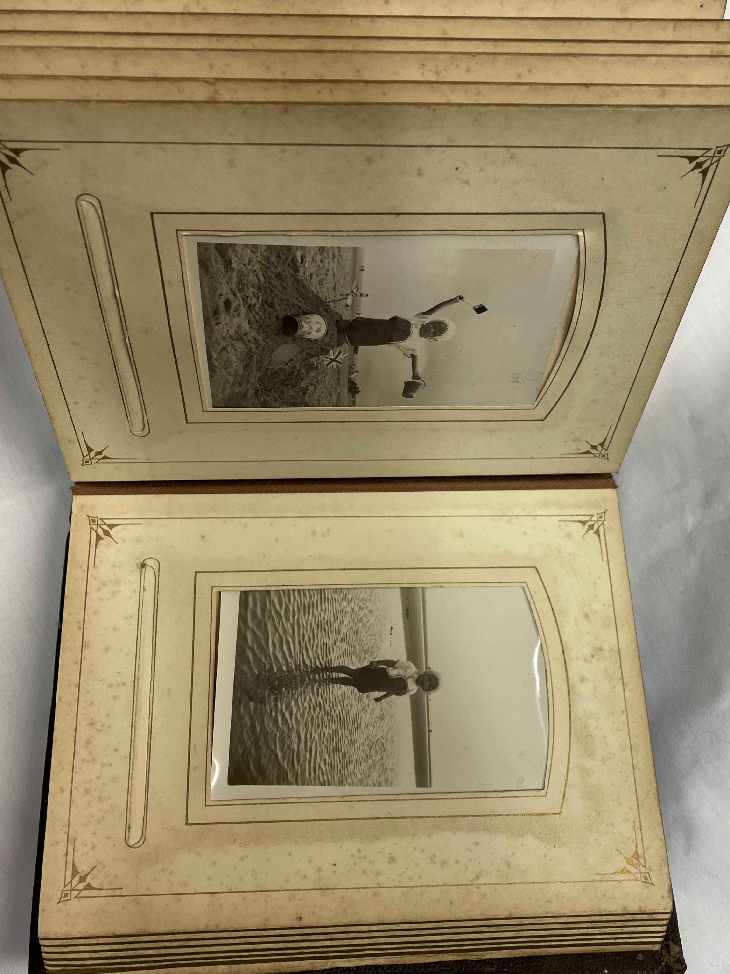 LEATHER BOUND GILT EDGED PHOTO ALBUM CONTAINING BLACK AND WHITE PHOTOS (CLASP A/F)