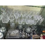 TWO SHELVES OF CUT GLASS - DRINKING GLASSES, DECANTERS,