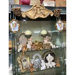 THREE SHELVES OF GILDED CORBELS AND FRIEZES AND CHERUB ORNAMENTS