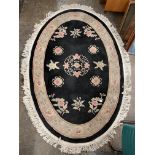 CHINESE BLACK WOOLEN OVAL FRINGED RUG