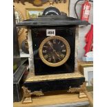 19TH CENTURY BLACK SLATE ARCHITECTURAL MANTLE CLOCK WITH APPLIED GILDED METAL FACE MASKS AND
