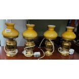 FOUR ITALIAN GILT TABLE LAMPS WITH AMBER SHADES