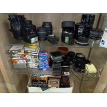 THREE SHELVES OF VARIOUS TAMRON AND OTHER CAMERA LENSES, FLASH UNITS,