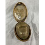 BRASS ENGRAVED EGG IN A HINGED NUT SHELL BOX