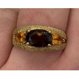 9CT GOLD SMOKY QUARTZ AND CITRINE THREE STONE RING WITH TEXTURED SHOULDERS SIZE O,