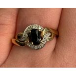 9CT GOLD SAPPHIRE AND DIAMOND CHIP CROSSOVER RING SIZE O, 2.