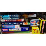 SHELF OF VARIOUS BOARD GAMES AND OVERSIZED LEGO