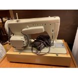 CASED SEWING MACHINE