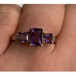 9CT GOLD AMETHYST THREE STONE AND DIAMOND CHIP RING SIZE O,