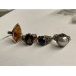FOUR SILVER DRESS RINGS INCLUDING AMBER MARQUISE, LAPIS CABOCHON AND SMOKY QUARTZ,