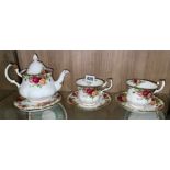 ROYAL ALBERT COUNTRY ROSES BACHELOR TEAPOT ON STAND AND A PAIR OF TEACUPS AND SAUCERS