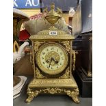 19TH CENTURY GILT METAL FRENCH MANTEL CLOCK WITH URN FINIAL AND MASK HANDLES 40CM H