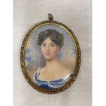 PORTRAIT MINIATURE IN A GILDED ORNATE FRAME WITH A LOCK OF HAIR GLAZED BACK