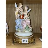 CAPODIMONTE CHERUB FIGURE GROUP BY CARPIE ON GILT METAL BASE