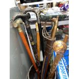 SELECTION OF WALKING STICKS SOME WITH HORN HANDLES AND POMMEL TOPS AND A REPRODUCTION SABRE