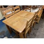 OAK EXTENDING DINING TABLE AND FOUR LADDER BACK CHAIRS