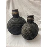PAIR OF CARVED WOODEN INDIAN MATKA POTS AND COVERS WITH IRON JAALI CHAIN WORK JACKETS