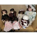 SHELF OF VINTAGE PORCELAIN HEADED DOLLS