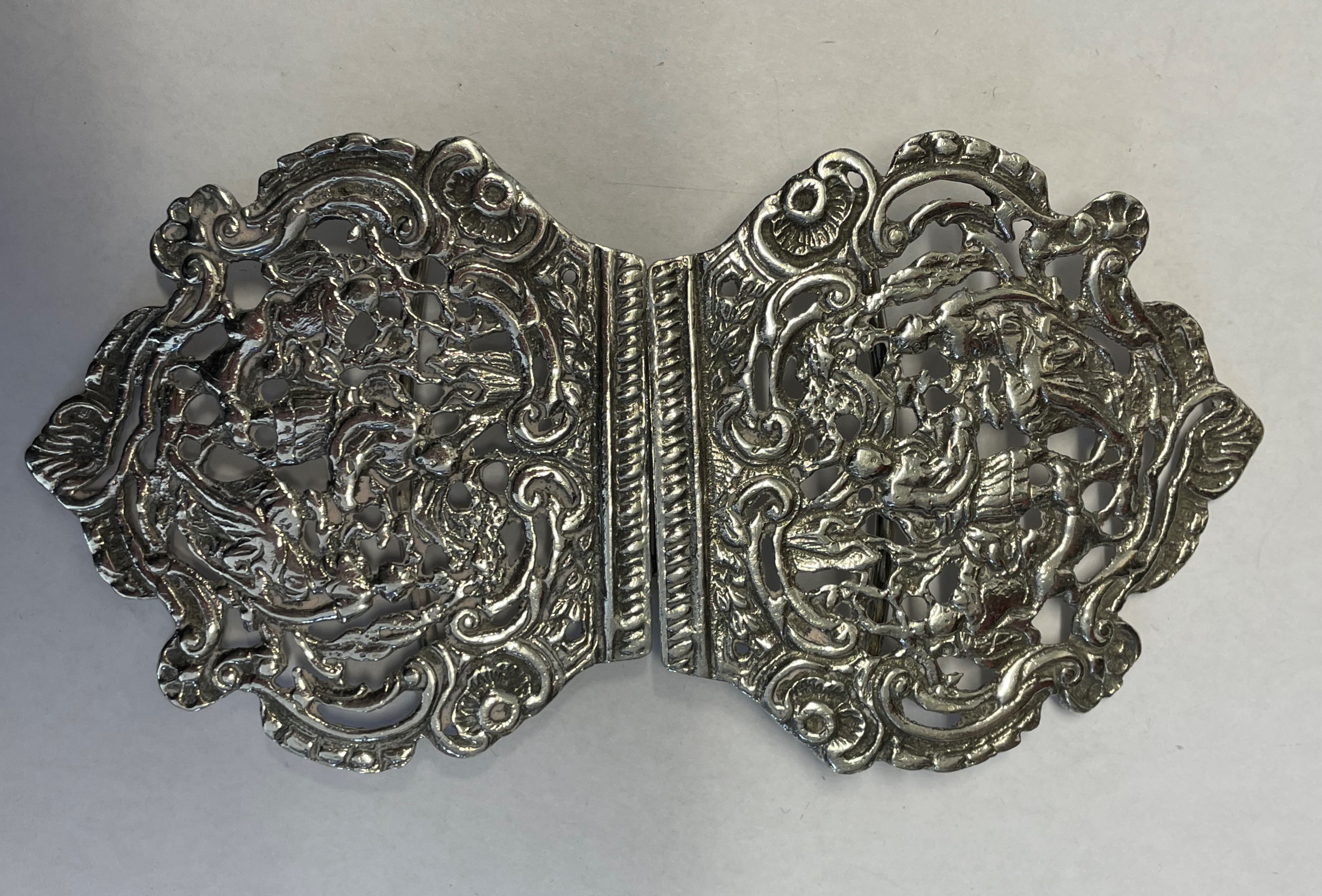 SILVER NURSE'S BUCKLE DECORATED WITH FIGURES AND FOLIAGE