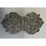 SILVER NURSE'S BUCKLE DECORATED WITH FIGURES AND FOLIAGE