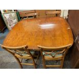 YEW CROSSBANDED EXTENDING DINING TABLE AND FOUR LATTICE BAR BACK CHAIRS