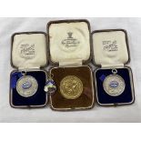 TWO CASED SILVER UNIVERSITY CYCLING CLUB MEDALLIONS,