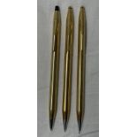 TWO CROSS 18K ROLLED GOLD CASED PROPELLING PENCILS AND A CROSS 10KT ROLLED GOLD CASED BALL POINT