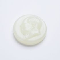 A White Jade Chairman Mao Badge, Signed and Dated 1951, 白玉雕毛主席像章 咏梅 1951年, diameter 2 in — 5.1 cm