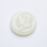 A White Jade Chairman Mao Badge, Signed and Dated 1951, 白玉雕毛主席像章 咏梅 1951年, diameter 2 in — 5.1 cm