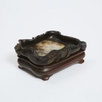 A Black, Beige and Russet Jade 'Lotus' Brush Washer, Ming Dynasty, 明 白玉提油荷叶形水洗, length 5.5 in — 13.9