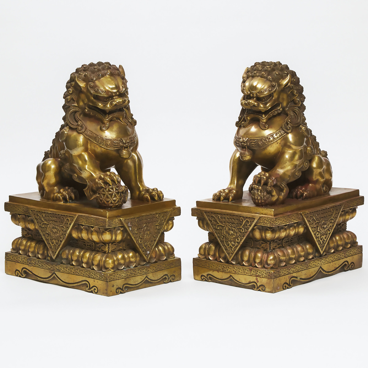 Pair of Buddhist Gilt Bronze Foo Dogs, early 20th century, 17.5 x 12 x 8.25 in — 44.5 x 30.5 x 21 cm