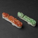 Two Jadeite 'Dragon' Belt Hooks, Qing Dynasty, 清 红翡及翡翠'苍龙教子'带钩一组两件, longest length 3.3 in — 8.5 cm (