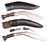 A kukri, with plain wood hilt, in its leather covered sheath with belt loop and 2 companion