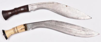 A kukri, with riveted wood grips, the blade stamped "D.K.W"; and another kukri, with brass mounted