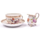 3x items of Dresden porcelain. A small cup and saucer with milk jug. Applied floral pattern with