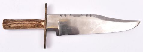 A Bowie knife, massive heavy clipped back blade 11", the hilt with staghorn grips and 5" flat bronze