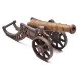 A decorative cannon, brass barrel 11", on its 2 wheeled iron carriage. GC £40-60
