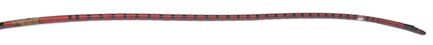 A Japanese bow, Yumi, 86" overall (7'2"), covered with black lacquer with bands of red lacquer