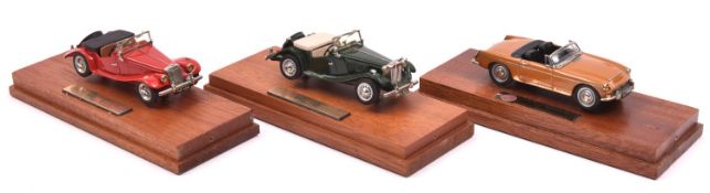 3x REA Models white metal 1:43 scale cars. MG TF in red. 1950 MG TD in dark green. MGC Roadster in