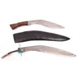 A kukri, the blade stamped with a broad arrow and "INDIA", with rivetted wood grips, no sheath;