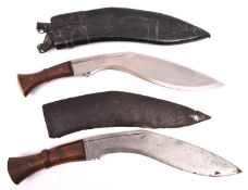 A kukri, the blade marked "C" over "ID44", with rivetted wood grips and brass pommel cap, in its