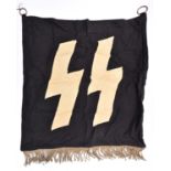 A Third Reich SS trumpet banner, 26" x 24", white runes on black background, silver alloy fringe. GC